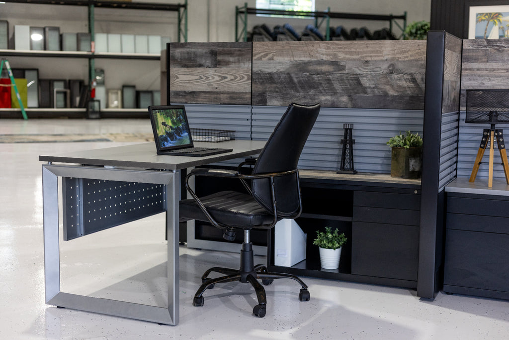 Modern office desk with a chair and computer setup in a room with shelves and decor.